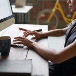 Woman typing on computer keyboard